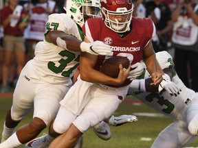 Arkansas quarterback Connor Noland is tackled by North Texas defender Brandon Garner in the second half of an NCAA college football game, Saturday, Sept. 15, 2018, in Fayetteville, Ark.