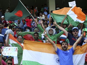 Indian and Bangladeshi supporters cheer for their teams before the start of the final one day international cricket match of Asia Cup between India and Bangladesh in Dubai, United Arab Emirates, Friday, Sept. 28, 2018.