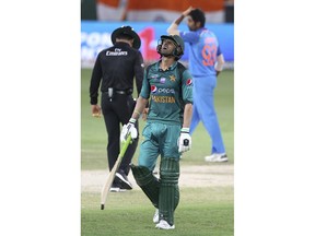 Pakistan's Shoaib Malik reacts as he leaves the field after being dismissed during the one day international cricket match of Asia Cup between India and Pakistan in Dubai, United Arab Emirates, Sunday, Sept. 23, 2018.