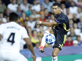 Juventus forward Cristiano Ronaldo goes for the ball during the Champions League, group H soccer match between Valencia and Juventus, at the Mestalla stadium in Valencia, Spain, Wednesday, Sept. 19, 2018.