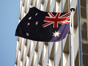 The Australian flag flies outside the Reserve Bank of Australia (RBA) headquarters in Sydney, Australia, on Tuesday, Sept. 3, 2013.