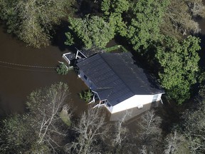 FILE-In this Monday, Oct. 10, 2016 file photo, a home sits in flood waters in Nichols, S.C. The residents of a tiny town in South Carolina who rebuilt after an inland flood from a hurricane destroyed 90 percent of the homes two years ago are uneasy as forecasters warn inland flooding from Hurricane Florence's rain could be one of the most dangerous and devastating parts of the storm.