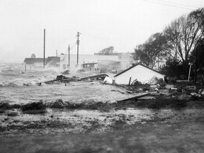 In this Oct. 15, 1954 file photo, high tides, whipped in by hurricane Hazel, shatter boats and buildings in Swansboro, N.C., as the storm lashes the Atlantic seaboard.