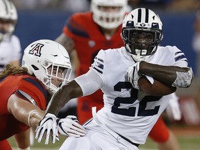 BYU running back Squally Canada (22) gets away from Arizona linebacker Colin Schooler during the first half of an NCAA college football game, Saturday, Sept. 1, 2018, in Tucson, Ariz.