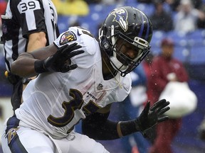 Rain drips off of Baltimore Ravens running back Javorius Allen's (37) helmet as he celebrates his touchdown during the second half of an NFL football game against the Buffalo Bills, Sunday, Sept. 9, 2018, in Baltimore.