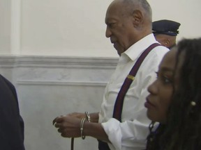 In this frame from video, Bill Cosby, centre, leaves the courtroom after he was sentenced to a three-to 10-year sentence for felony sexual assault on Tuesday, Sept. 25, 2018, in Norristown, Pa.