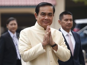 FILE -  In this Tuesday, Sept. 11, 2018, file photo, Thai Prime Minister Prayuth Chan-ocha, center, arrives at the government house for a cabinet meeting in Bangkok, Thailand. Prayuth on Monday declared that he is "interested" in the country's politics, providing further indication that he will run in elections scheduled for early next year.