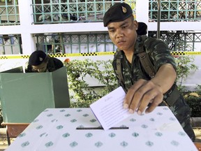FILE - In this Feb. 2, 2014, file photo, a Thai soldier casts his vote during the general election at a polling station in Bangkok, Thailand. Thailand has taken another step toward holding elections next year in 2019 by easing some restrictions on political activities to allow parties to conduct basic functions, but they are still barred from campaigning.