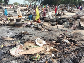 Women sift through the remains of a market blown up during an attack on September 20, 2018, in Amarwa, some 20 kilometres (12 miles) from Borno state capital Maiduguri. - Nine people were killed and nine others injured when Boko Haram fighters raided Kalari Abdiye and Amarwa villages in northeast Nigeria, the civilian militia said.