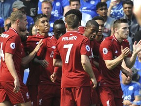 Liverpool's Sadio Mane, centre, celebrates after scoring his side's first goal with teammates during the English Premier League soccer match between Leicester City and Liverpool at the King Power Stadium in Leicester, England, Saturday, Sept. 1, 2018.