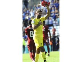 Liverpool goalie Alisson Becker applauds fans after the English Premier League soccer match between Leicester City and Liverpool at the King Power Stadium in Leicester, England, Saturday, Sept. 1, 2018.