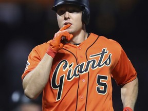 San Francisco Giants' Nick Hundley celebrates after hitting a home run off Los Angeles Dodgers' Hyun-Jin Ryu during the second inning of a baseball game Friday, Sept. 28, 2018, in San Francisco.
