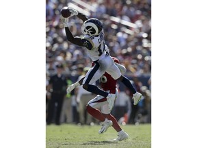 Los Angeles Rams wide receiver Brandin Cooks catches a pass over Arizona Cardinals defensive back Budda Baker during the second half of an NFL football game Sunday, Sept. 16, 2018, in Los Angeles.