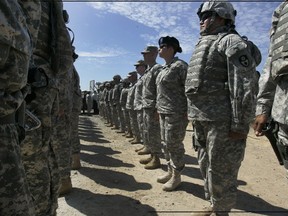 FILE - This Aug. 18, 2010, file photo shows California National Guard troops, who are part of Task Force Sierra, deployed at the border along with Border Patrol Agents near the California/Mexico border in San Diego. California Gov. Jerry Brown on Friday, Sept. 28, 2018, extended the state National Guard's participation in President Donald Trump's border deployment by six months, a low-key announcement that was made without any of the acrimony that characterized his early negotiations with the federal government. The California National Guard said in a press release that the mission will now run until the end of March 2019.