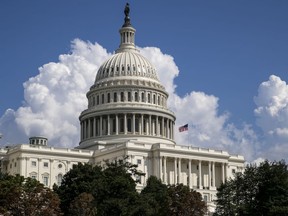 FILE - In this Monday, Sept. 3, 2018 file photo, an American flag flies on the U.S. Capitol in Washington. Christine Margaret Blasey Ford has accused Supreme Court nominee Brett Kavanaugh of pinning her to a bed at a Maryland house party in the early 1980s and trying to take her clothes off, an allegation he denies. Her story has shaken up the battle over Kavanaugh's confirmation, and Senate Republicans are calling for a public hearing with both accuser and accused testifying.