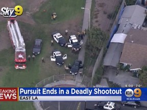 This still image taken from video provided by CBS2/KCAL9 shows the scene of gunfight at an East Los Angeles park that has wounded two Los Angeles County sheriff's deputies and left a suspect dead, Wednesday, Sept. 19, 2018. Sheriff Jim McDonnell says the deputies, both veterans of the department in their early 30s, are in serious but stable condition Wednesday night and their wounds are non-life threatening. (CBS2/KCAL9 via AP)