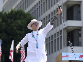 FILE - In this June 30, 2018 file photo, Taboo from Black Eyed Peas performs "Where is the Love?" at the "Families Belong Together: Freedom for Immigrants" March in Los Angeles. The Black Eyed Peas tackle gun violence at schools and immigration in two new music videos for their song, "Big Love." The trio released the videos Friday, Sept. 21, 2018