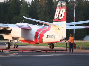Cal Fire's Melody Brown helps reload tanker 88 with retardant Monday evening, Sept. 3, 2018, during her first season at the Grass Valley Air Attack Base. Thirty thousand gallons of retardant was administered to 4 air tankers Monday for the North Fire.