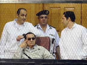FILE - In this Saturday, Sept. 14, 2013 file photo, former Egyptian President Hosni Mubarak, seated, and his two sons Gamal Mubarak, left, and Alaa Mubarak, right, attend a hearing in a courtroom at the Police Academy, Cairo, Egypt.  Egypt's highest appeals court has rejected a motion by  Mubarak and his two sons to overturn their conviction on corruption charges.  Saturday, Sept. 22, 2018 ruling by the Court of Cessation, Egypt's final recourse for appeals in criminal cases, dashed any hope that Gamal, Mubarak's younger son and one-time heir apparent, could run for public office.