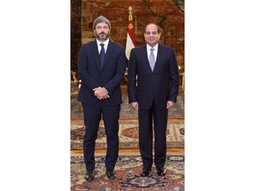 In this photo released by the Egyptian Presidency, Egyptian President Abdel-Fattah el-Sissi, right, poses for a photo with Roberto Fico, president of Italy's Chamber of Deputies, at the presidential palace in Cairo, Egypt, Monday, Sept. 17, 2018. Fico said a final resolution of the 2016 killing of a graduate student in Egypt will help boost relations between the two nations. A presidential statement said el-Sissi assured Fico of his nation's commitment to "full transparency" in its cooperation with Italy on the case. (Egyptian Presidency via AP)