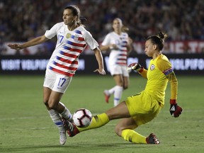 United States' Tobin Heath, left, collides with Chile goalkeeper Christiane Endler during the first half of an international friendly soccer match Friday, Aug. 31, 2018, in Carson, Calif.