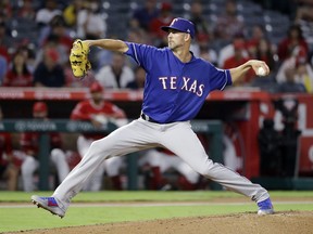 Texas Rangers starting pitcher Mike Minor throws to the Los Angeles Angels during the first inning of a baseball game Monday, Sept. 10, 2018, in Anaheim, Calif.