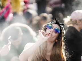 A resident smokes a marijuana joint during the 420 Day festival on the lawns of Parliament Hill in Ottawa, Ontario, Canada, on Friday, April 20, 2018.