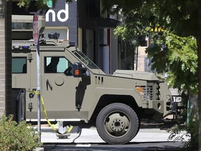 A police vehicle leaves the scene where a man was shot and killed by Sacramento Police Thursday, Sept. 6, 2018, in Sacramento, Calif. Responding to a 911 call of a masked man carrying a gun, a SWAT team located the man in a backyard and two officers opened fire. Police say a gun was found next to the man, but it's unclear if he pointed it at officers or fired at them.