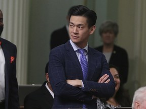 Assemblyman Evan Low, D-Campbell, watches the debate over a bill during the Assembly session Friday, Aug. 31, 2018, in Sacramento, Calif. Low announced Friday that he is ending his effort this year to pass a bill declaring gay conversion therapy a fraudulent practice.