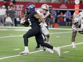 TCU running back Darius Anderson (6) runs past Ohio State linebacker Malik Harrison (39) and defensive lineman Robert Landers (67) for a long touchdown run during the first half of an NCAA college football game in Arlington, Texas, Saturday, Sept. 15, 2018.