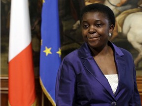 In this Sunday, April 28, 2013 file photo, Italian Integration Minister Cecile Kyenge arrives at the Premier's office in Rome's Chigi palace. The newspaper of Italy's anti-immigrant Northern League party has come under fire for a new feature listing the daily whereabouts of the country's first black Cabinet minister. The "Here's Cecile Kyenge" feature was launched days after the Congolese-born Kyenge was once again heckled during a weekend appearance in Brescia by Northern League and other right-wing extremists.