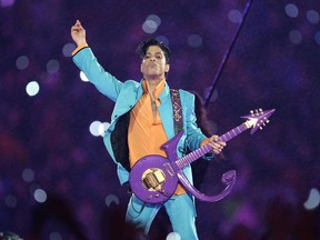 FILE - In this Feb. 4, 2007, file photo, Prince performs during the halftime show at the Super Bowl XLI football game at Dolphin Stadium in Miami. Thousands of Prince fans have signed a petition asking federal authorities to open a grand jury investigation into his 2016 death.