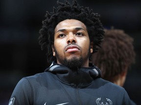 FILE - In this April 1, 2018, file photo, Milwaukee Bucks guard Sterling Brown is seen during an NBA basketball game in Denver. A Milwaukee police officer involved in the stun gun arrest of Bucks' player Sterling Brown has been fired because of social media posts. Police Chief Erik Morales disclosed the firing during a speech at Marquette University on Thursday, Sept. 13, 2018, but he did not name the officer. Brown sued the police department in June and accused officers of using excessive force and targeting him because he's black.