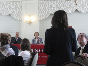 FILE - In this Feb. 22, 2018, file photo, Republican Senate candidate Leah Vukmir, standing, asks a question of Democratic U.S. Sen. Tammy Baldwin during a luncheon in Madison, Wis. Vukmir faces Baldwin in one of the most expensive Senate races in the country.