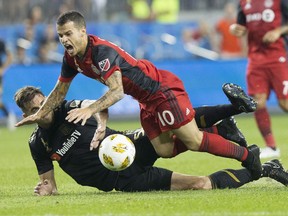 Toronto FC's Sebastian Giovinco (10) is brought down by Los Angeles FC's Dejan Jakovic during first half MLS action in Toronto on Saturday September 1, 2018.