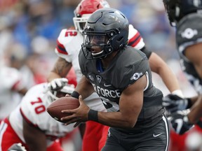 Air Force quarterback Arion Worthman, front, runs for yardage as Stony Brook linebacker Keegan Henderson, center, and defensive lineman Brandon Lopez pursue in the first half of an NCAA college football game Saturday, Sept. 1, 2018, at Air Force Academy, Colo.