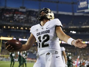 Colorado quarterback Steven Montez celebrates after his touchdown run against Colorado State in the first half of an NCAA college football game Friday, Aug. 31, 2018, in Denver.