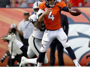 Denver Broncos quarterback Case Keenum (4) fumbles under pressure from Oakland Raiders defensive end Arden Key (99) during the second half of an NFL football game, Sunday, Sept. 16, 2018, in Denver. The Broncos recovered the ball in their 20-19 win.