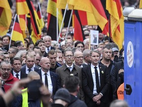 Bjoern Hoecke, leader of the Alternative for Germany, AfD, in German state of Thuringia, second from right, participates in a commemoration march in Chemnitz, eastern Germany, Saturday, Sept. 1, 2018.