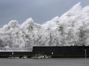 High waves hit breakwaters at a port of Aki, Kochi prefecture, western Japan, Tuesday Sept. 4, 2018.