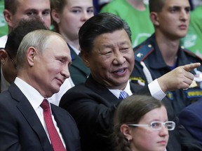Russian President Vladimir Putin, left, and Chinese President Xi Jinping visit the Ocean Russian children recreation center after at the Eastern Economic Forum in Vladivostok, Russia, Wednesday, Sept. 12, 2018.