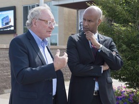 P.E.I. Premier Wade MacLauchlan, left, chats with Immigration Minister Ahmed Hussen at a meeting of the Atlantic Growth Strategy Leadership Committee in Summerside, P.E.I., on July 10, 2018. Prince Edward Island's government is scrapping a controversial business immigration program where participants have drawn federal investigations for allegedly never settling on the Island. In a news release today the province says it will no longer accept applications from immigrants looking to set up a business on the Island in entrepreneur stream of the Provincial Nominee Program.