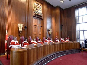 The Supreme Court of Canada says internet service providers can recover some of the costs of helping movie companies and other copyright holders find illegal downloaders. Supreme Court of Canada justices sit during a welcoming ceremony for Justice Sheilah Martin, in Ottawa on Friday, March 23, 2018.