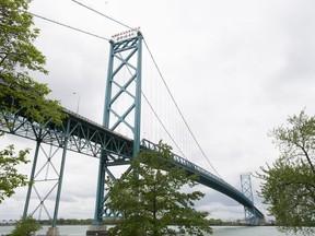 The Crown corporation overseeing construction of a new bridge at the busiest border crossing between Canada and the United States says the span will cost $5.7 billion. The Ambassador bridge is seen crossing the Detroit river from Windsor, Ont. on Friday, May 26, 2017.
