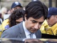 Former CBC radio host Jian Ghomeshi leaves a Toronto court after signing a peace bond, on Wednesday, May 11, 2016. An editor at the New York Review of Books has parted ways with the prestigious literary publication amid controversy over his decision to publish a personal essay by disgraced former radio host Jian Ghomeshi.