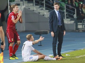 Rangers' head coach Steven Gerrard, right, Rangers' Scott Arfield, centre, Ufa's Dmitri Zhivoglyadov react during the Europa League play-off round, second leg soccer match between Ufa and Rangers at Neftyanik stadium in Ufa, Russia, Thursday, Aug. 30, 2018. Arfield went to work before 58,865 rabid fans last Sunday when his Glasgow Rangers visited city rival Celtic. He will likely face rows of empty seats this Sunday when Canada hosts the U.S. Virgin Islands at the IMG Academy in Bradenton, Fla., in a CONCACAF Nations qualifying game.