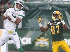 Saskatchewan Roughriders' Justin Cox (31) makes an interception on Edmonton Eskimos' Derel Walker (87) during first half action in Edmonton, Alta., on Friday July 8, 2016. A former player with the CFL Saskatchewan Roughriders has pleaded guilty to assault causing bodily harm. A trial for Justin Cox was to begin this morning, but he instead entered the guilty plea.