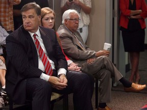 Calgary Flames owners group members Murray Edwards, left, and Clay Riddell, listen as newly-named Calgary Flames President of Hockey Operations Brian Burke is annouced in Calgary, on Thursday, Sept. 5, 2013. Riddell, billionaire businessman and co-owner of the Calgary Flames, has died.