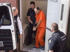 Matthew Vincent Raymond, charged with four counts of first degree murder, is taken from provincial court in Fredericton on Monday, Aug. 27, 2018. A video has emerged where the alleged murderer of four people made false statements about Muslims and criticized a Parliamentary motion that condemns Islamophobia.