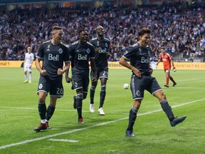 Someone's streak will end when the Vancouver Whitecaps take on the Seattle Sounders in a key playoff battle on Saturday. Vancouver Whitecaps' Jake Nerwinski, from left, Alphonso Davies, Kei Kamara and Nicolas Mezquida celebrate Mezquida's goal against the San Jose Earthquakes during the second half of an MLS soccer game in Vancouver on Saturday, Sept. 1, 2018.